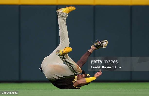 Juan Soto of the San Diego Padres dives to catch a fly ball hit by Ozzie Albies of the Atlanta Braves to end the eighth inning at Truist Park on...