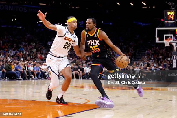 Kevin Durant of the Phoenix Suns drives against Zeke Nnaji of the Denver Nuggets during the second half at Footprint Center on April 06, 2023 in...