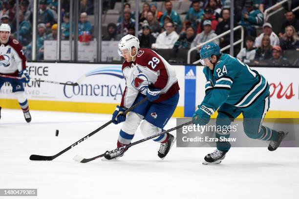 Nathan MacKinnon of the Colorado Avalanche and Jacob Peterson of the San Jose Sharks go for the puck in the third period at SAP Center on April 06,...