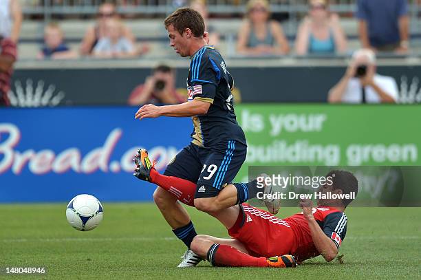 Logan Emory of the Toronto FC slides into Antoine Hoppenot of the Philadelphia Union at PPL Park on July 8, 2012 in Chester, Pennsylvania. The Union...