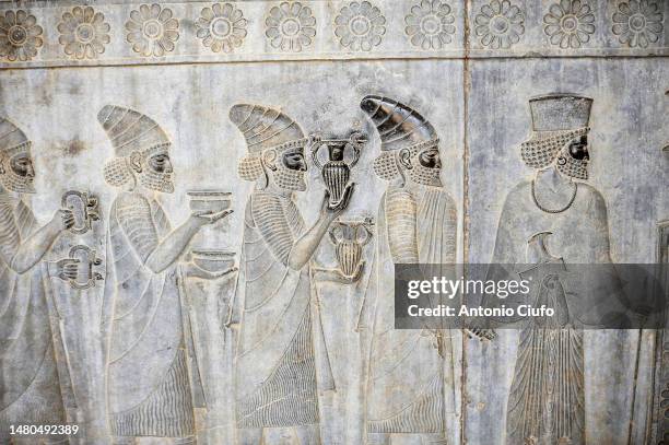 bas-relief from the apadana depicting the lydian people bringing gifts to the king, persepolis, iran - empire stock pictures, royalty-free photos & images