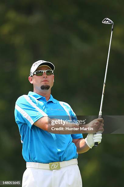 Troy Kelly watches his tee shot on the third hole during the final round of the Greenbrier Classic at the Old White TPC on July 8, 2012 in White...