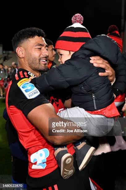 Richie Mo'unga of the Crusaders celebrates with his son Marley after playing his 100th super rugby match during the round seven Super Rugby Pacific...