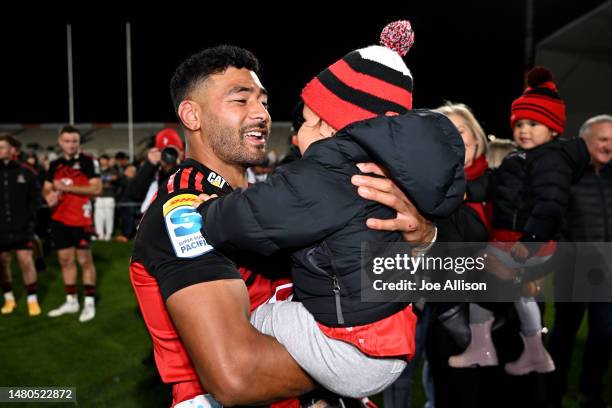 Richie Mo'unga of the Crusaders celebrates with his son Marley after playing his 100th super rugby match during the round seven Super Rugby Pacific...