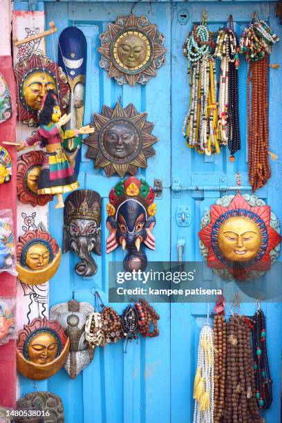 masks, pottery,souvenirs, hanging in front of the shop on swayambhunath stupa in kathmandu, nepal - durbar square stock pictures, royalty-free photos & images