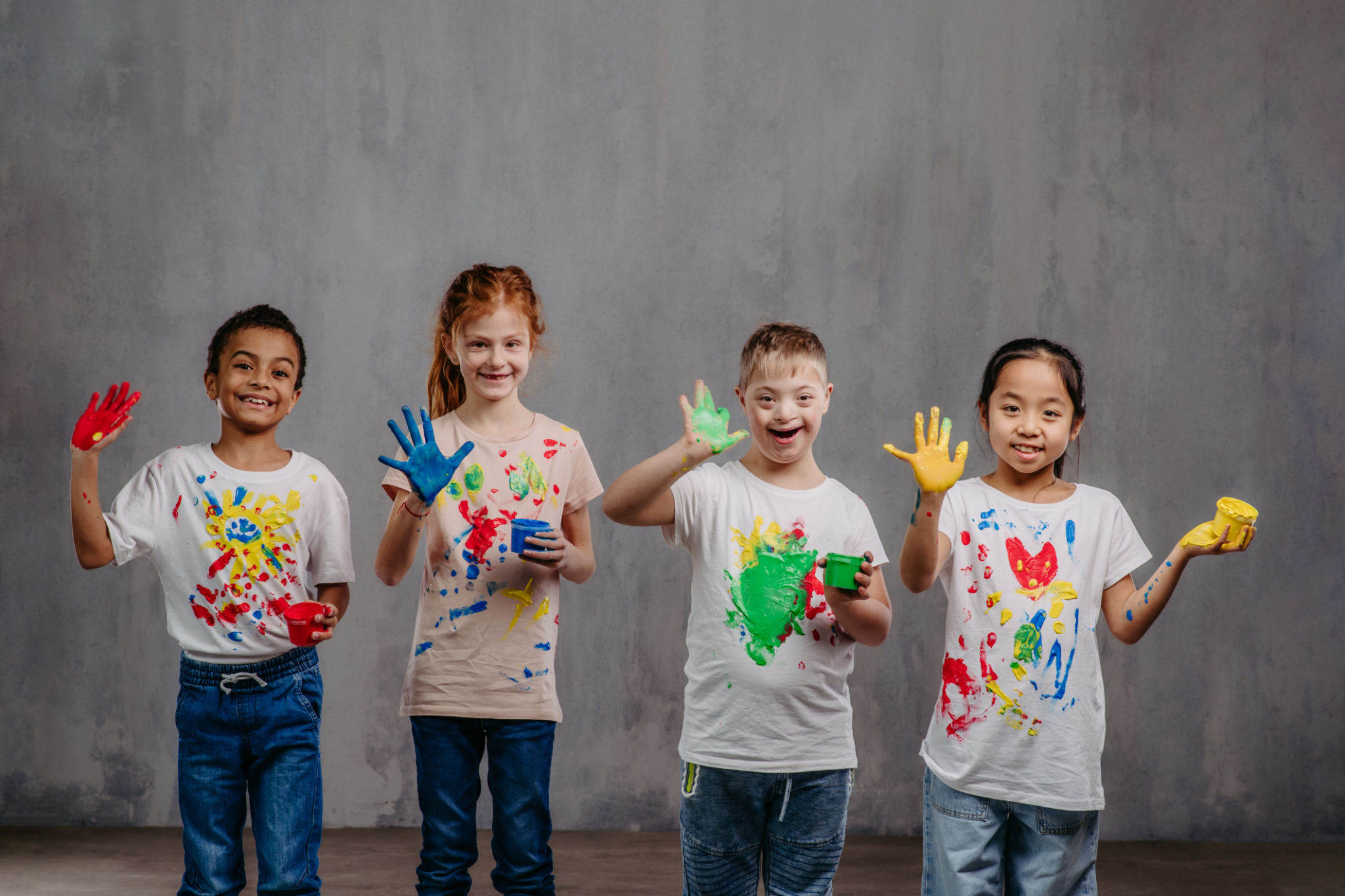 Portrait of happy kids with finger colours and painted t-shirts, studio shoot. Portrait of happy kids with finger colours and painted t-shirts, studio shoot.