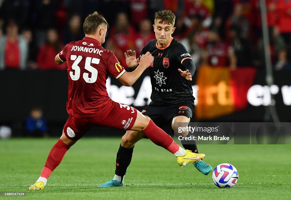 Luka Jovanovic of Adelaide United competes with Joel King of Sydney