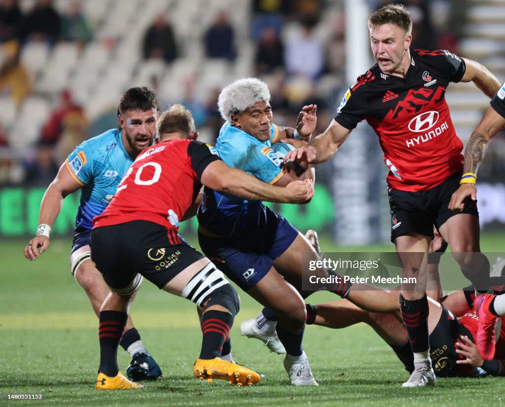 Fine Inisi of Moana Pasifika is tackled by Tom Christie of the