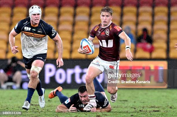 Tate McDermott of the Reds breaks through the defence during the round seven Super Rugby Pacific match between Queensland Reds and ACT Brumbies at...