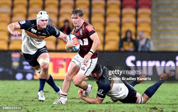 Tate McDermott of the Reds breaks through the defence during the round seven Super Rugby Pacific match between Queensland Reds and ACT Brumbies at...