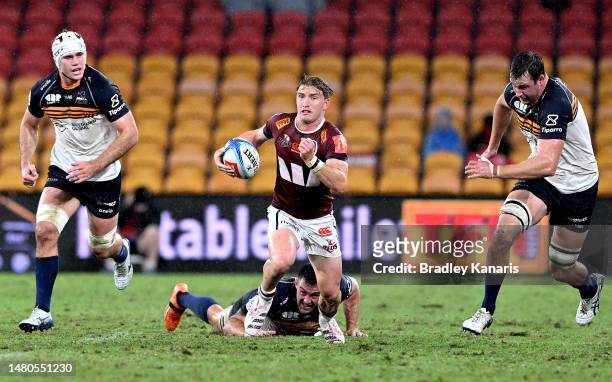 Tate McDermott of the Reds breaks through the defence during the round seven Super Rugby Pacific match between Queensland Reds and ACT Brumbies at...