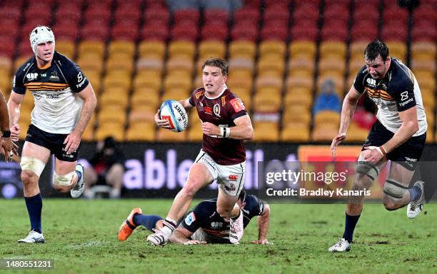 Tate McDermott of the Reds breaks through the defence during the round seven Super Rugby Pacific match between Queensland Reds and ACT Brumbies at...