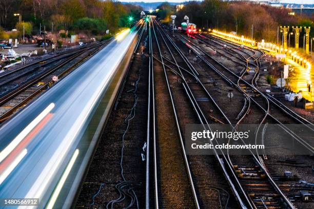 blurred motion of passenger train in early evening - journey stock pictures, royalty-free photos & images