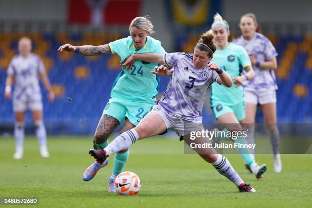 Larissa Crummer of Australia battles for possession with Emma Mukandi of Scotland during the Women's International Friendly match between Australia...