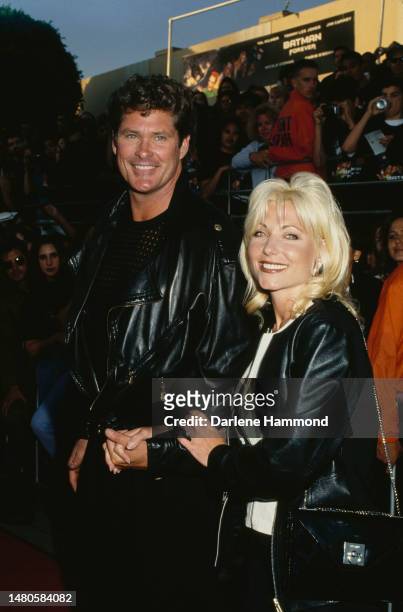 American actor and singer David Hasselhoff and his wife, American actress Pamela Bach attend the Westwood premiere of 'Batman Forever,' held at...
