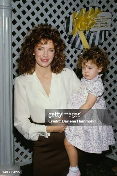 American actress Jaclyn Smith holding her daughter, Spencer Margaret Richmond, attend the Young Musicians Foundation's Celebrity Mother-Daughter...