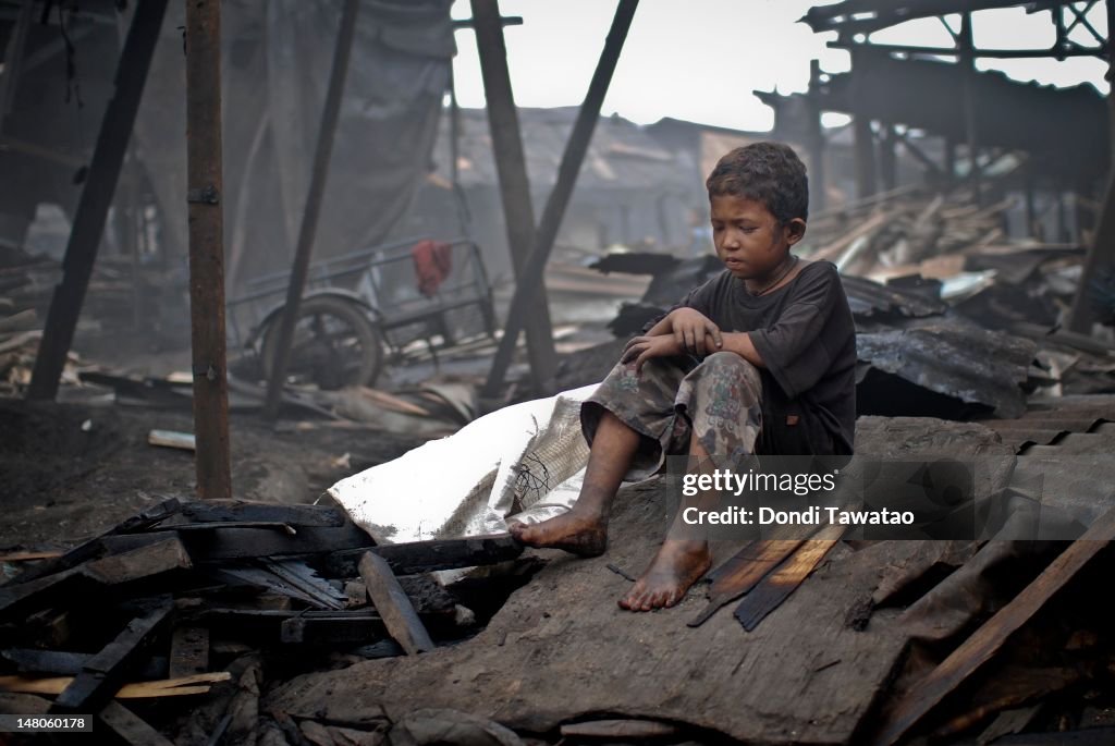 Pinoy Laborer A Filipino child laborer takes a rest in the charcoal dump of Port ...