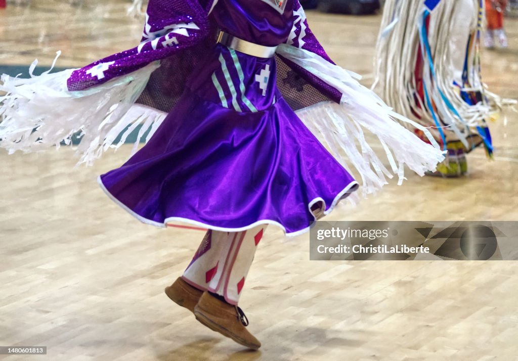First Nations' Powwow at Earl Marriott Secondary School, White Rock, British Columbia — March 31 to April 2, 2023. This dancer is wearing colourful regalia.