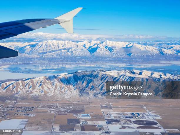 aerial views of the lake utah, wasatch mountains and airplane wing - utah lake stock pictures, royalty-free photos & images