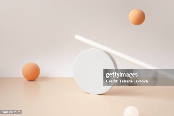 trendy geometric figures making abstract composition. pastel orange spheres, white cylinder and circle on beige gray background with copy space. - sphère 3d photos et images de collection