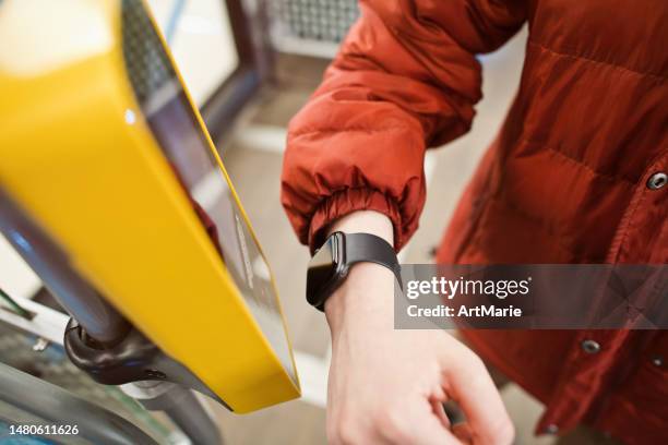 woman paying for a bus ticket with smartwatch - contactless payment bus stock pictures, royalty-free photos & images