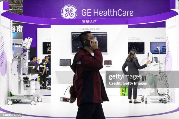 The exhibitors stand by medical equipment of General Electric during the 2023 World Health Expo held in Wuhan International Expo Center on April...