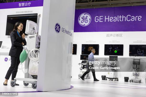 The exhibitors stand by medical equipment of General Electric during the 2023 World Health Expo held in Wuhan International Expo Center on April...