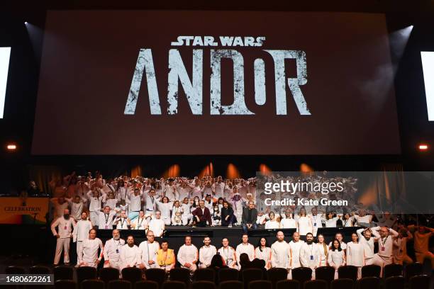 Michael Wilkinson, Diego Luna and Tony Gilroy pose with Cosplayers onstage at the Andor studio panel at the Star Wars Celebration 2023 in London at...