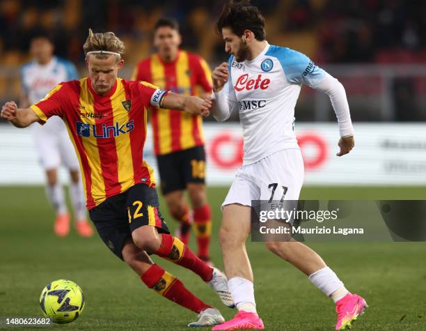 Morten Hjulmand of Lecce competes for the ball with Khvicha Kvaratskhelia of Napoli during the Serie A match between US Lecce and SSC Napoli at...