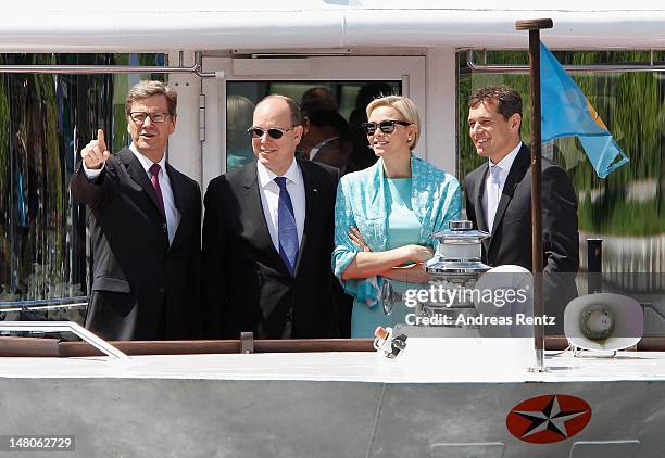 German Foreign Minister Guido Westerwelle, Prince Albert II with Princess Charlene of Monaco and Michael Mronz smile during a boat tour on the Spree...