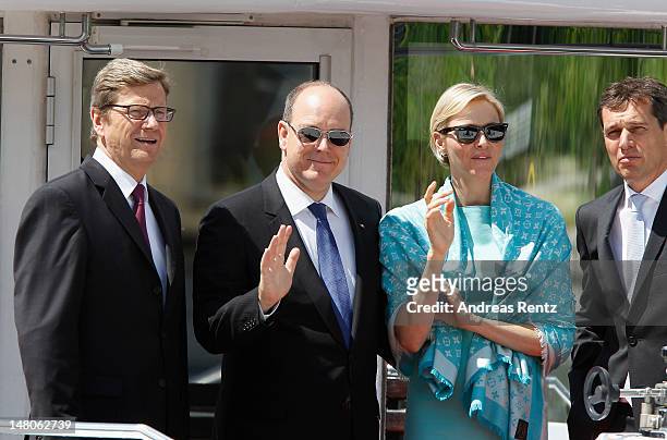 German Foreign Minister Guido Westerwelle, Prince Albert II with Princess Charlene of Monaco and Michael Mronz smile during a boat tour on the Spree...