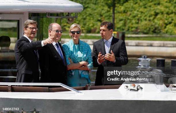 German Foreign Minister Guido Westerwelle, Prince Albert II with Princess Charlene of Monaco and Michael Mronz smile during a boat tour on the Spree...