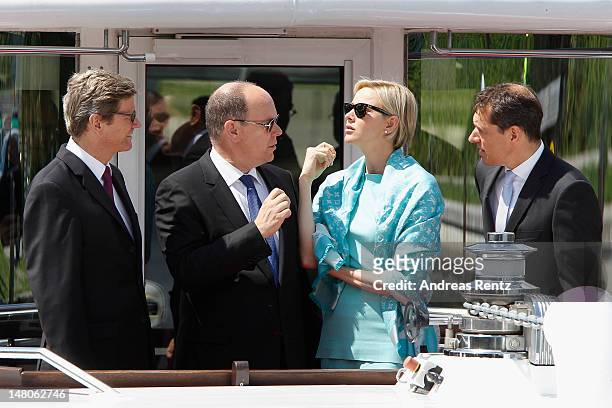 German Foreign Minister Guido Westerwelle, Prince Albert II with Princess Charlene of Monaco and Michael Mronz smile during a boat tour on the Spree...