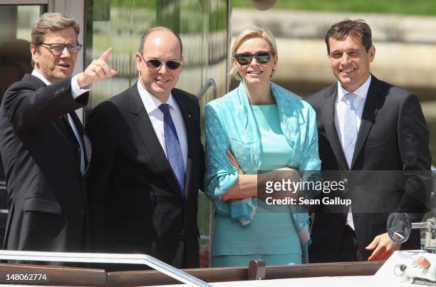Prince Albert II and Princess Charlene of Monaco ride a boat with German Foreign Minister Guido Westerwelle and his partner Michael Mronz on the...