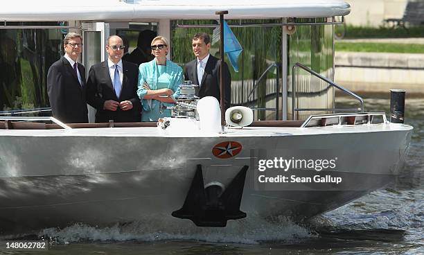 Prince Albert II and Princess Charlene of Monaco ride a boat with German Foreign Minister Guido Westerwelle and his partner Michael Mronz on the...