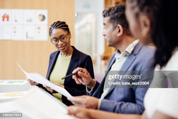 multi-ethnic business professionals discussing new marketing strategy . male and female coworkers during their business meeting - coordinator stock pictures, royalty-free photos & images