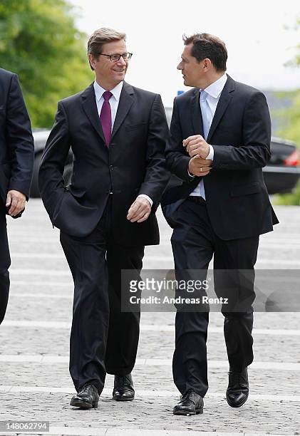German Foreign Minister Guido Westerwelle and Michael Mronz arrive for a boat tour with the Monaco royal couple on the Spree canal on July 9, 2012 in...