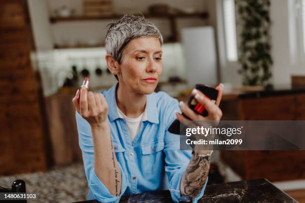 applying make-up - lippenstift stockfoto's en -beelden