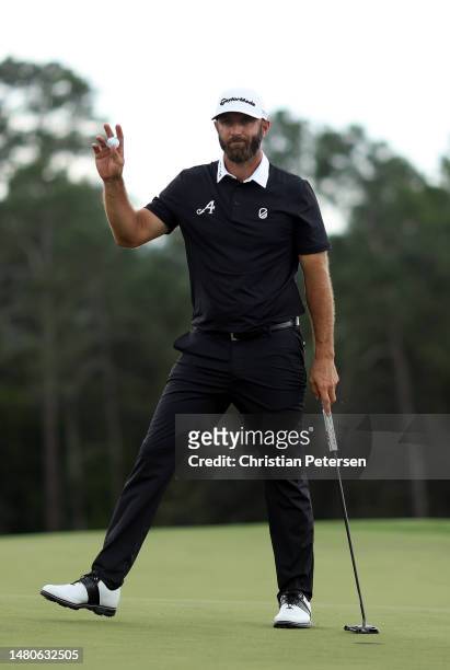 Dustin Johnson of the United States reacts to his putt on the 18th green during the second round of the 2023 Masters Tournament at Augusta National...
