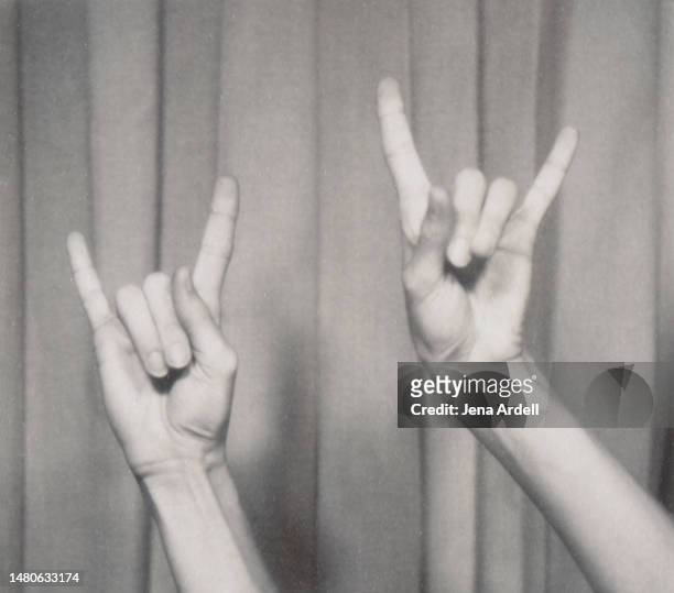 rock n roll hand symbol, gesturing music hand sign, horn sign hands music fan concert - heavy fotografías e imágenes de stock