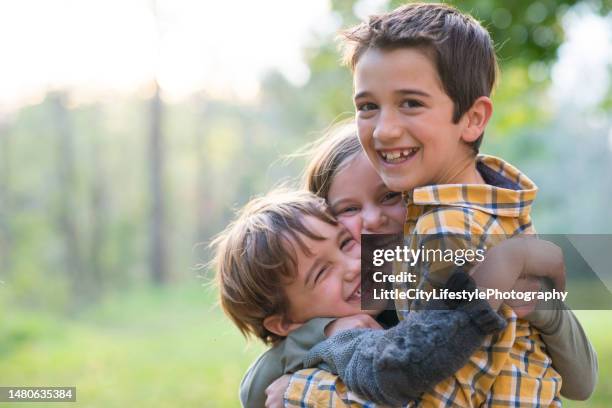 sibling hug - sister stock pictures, royalty-free photos & images