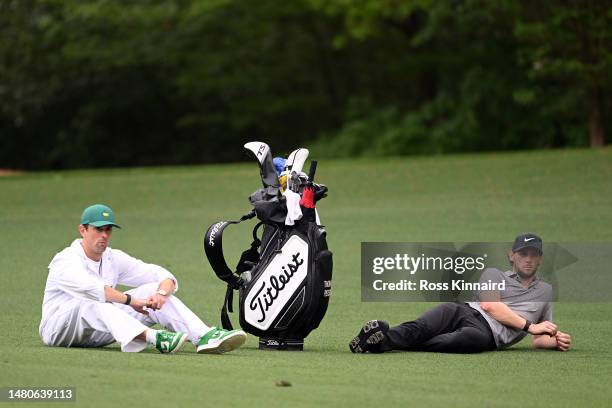 Thomas Pieters of Belgium and his caddie Adam Marrow wait on the 11th hole during a weather delay during the second round of the 2023 Masters...