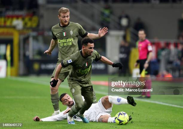 Ismael Bennacer and Tommaso Pobega of AC Milan battle for possession with Francesco Caputo of Empoli FC during the Serie A match between AC Milan and...