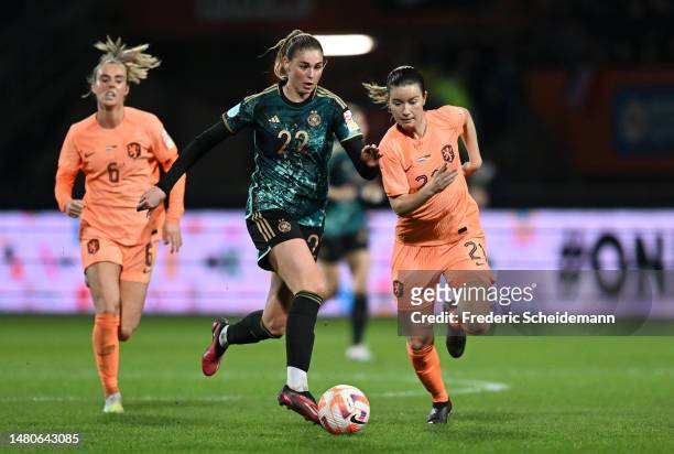 Jule Brand of Germany runs with the ball whilst under pressure from Damaris Egurrola of Netherlands during the Women's international friendly match...