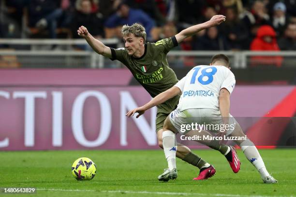 Alexis Saelemaekers of AC Milan is put under pressure by Razvan Marin of Empoli FC during the Serie A match between AC Milan and Empoli FC at Stadio...