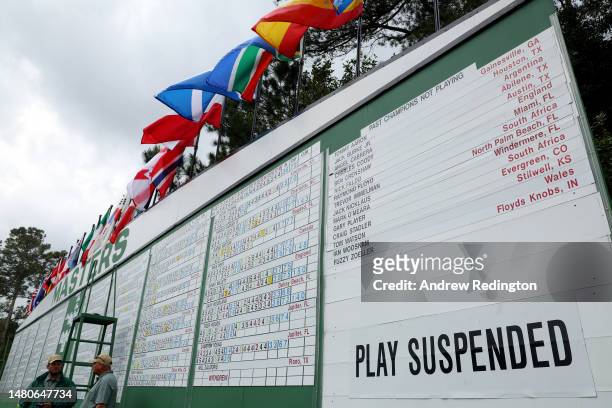 Signage that reads 'Play Suspended' due to weather on the leaderboard during the second round of the 2023 Masters Tournament at Augusta National Golf...