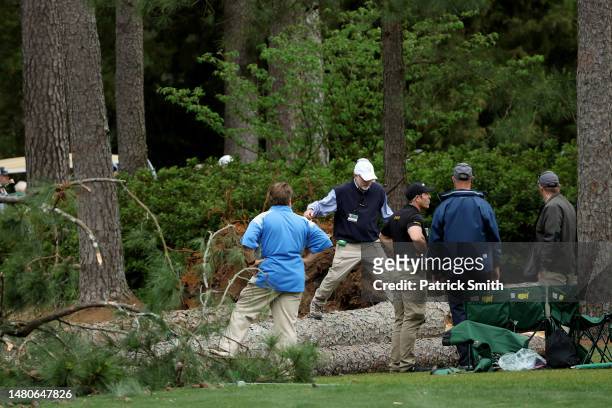 Course officials look over fallen trees on the 17th tee during the second round of the 2023 Masters Tournament at Augusta National Golf Club on April...