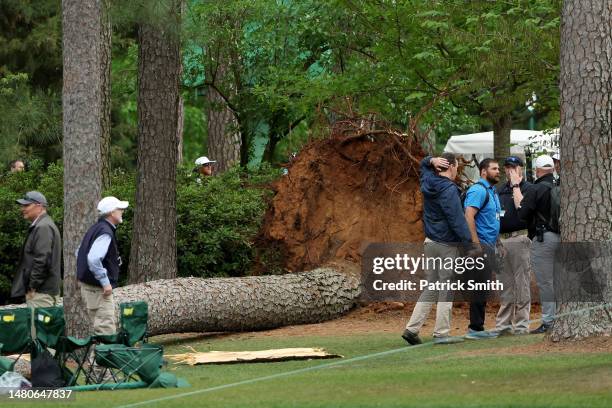 Course officials look over fallen trees on the 17th tee during the second round of the 2023 Masters Tournament at Augusta National Golf Club on April...