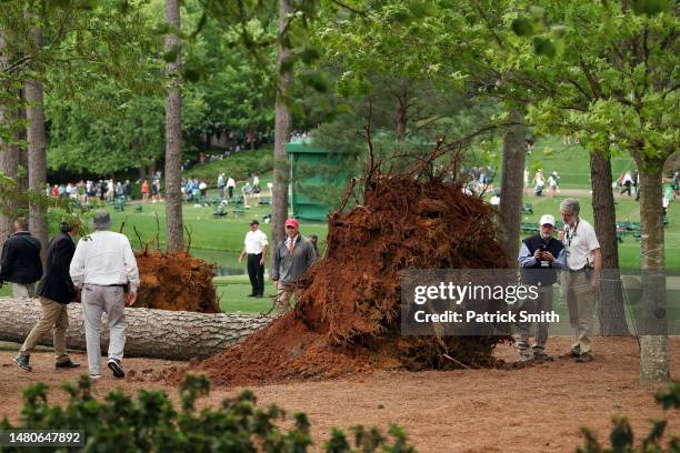 Course officials look over fallen trees on the 17th hole during the second round of the 2023 Masters Tournament at Augusta National Golf Club on...