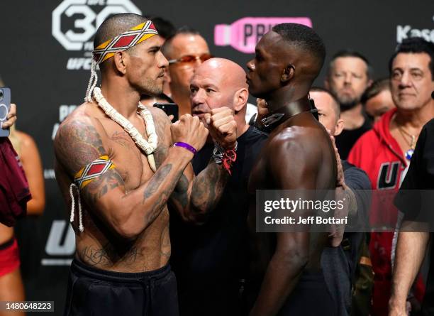 Opponents Alex Pereira of Brazil and Israel Adesanya of Nigeria face off during the UFC 287 ceremonial weigh-in at Kaseya Center on April 07, 2023 in...